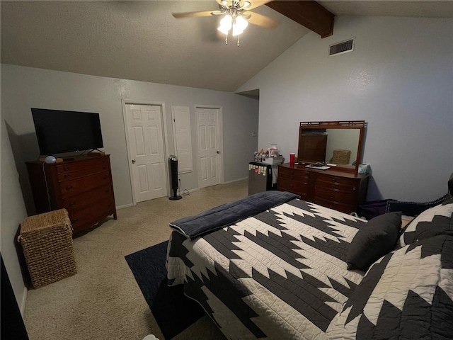 bedroom with lofted ceiling with beams, ceiling fan, light carpet, baseboards, and visible vents