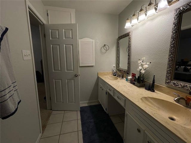 bathroom featuring tile patterned floors, a sink, and double vanity