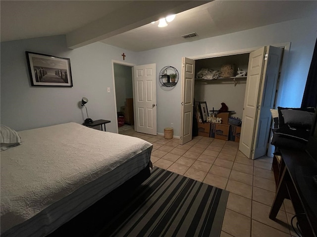 bedroom with visible vents, a closet, and light tile patterned floors