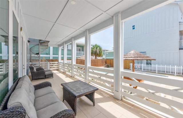 sunroom / solarium with a paneled ceiling