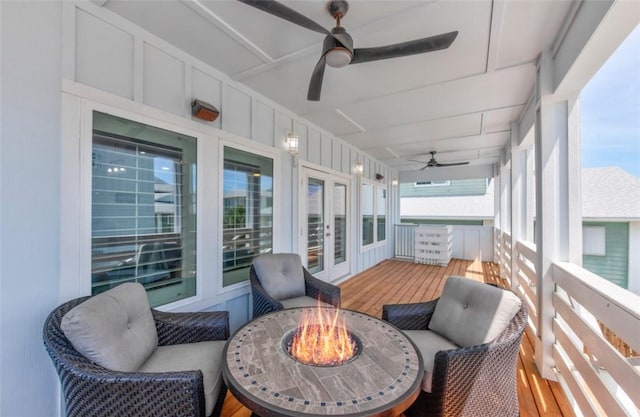 sunroom with a wealth of natural light and ceiling fan