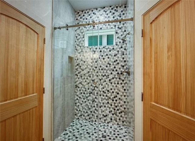 bathroom with a shower with door