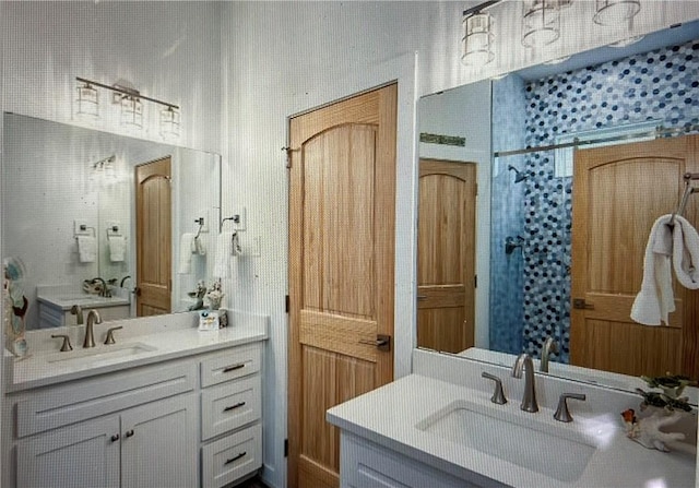 bathroom featuring walk in shower and vanity