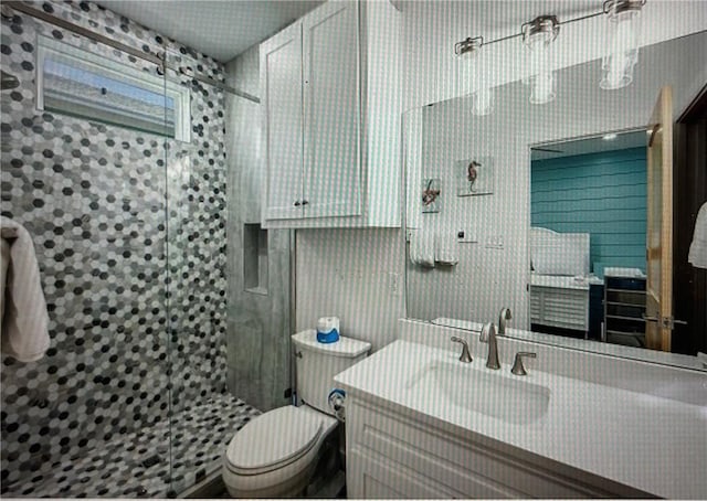 bathroom featuring walk in shower, vanity, and toilet