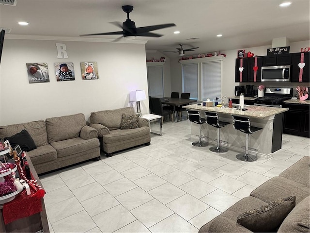 tiled living room with ceiling fan, ornamental molding, and sink