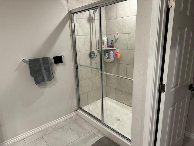 bathroom featuring tile patterned flooring and a shower with shower door