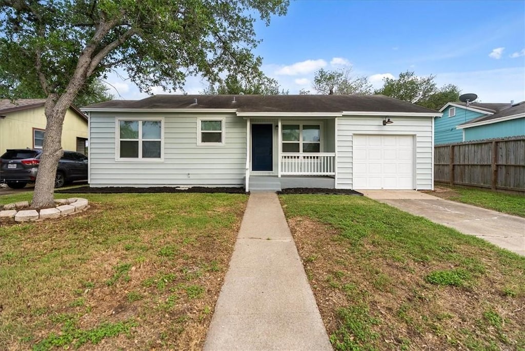 1005 Anderson St, Corpus Christi, TX 78411 - ranch-style house featuring an attached garage, covered porch, and driveway