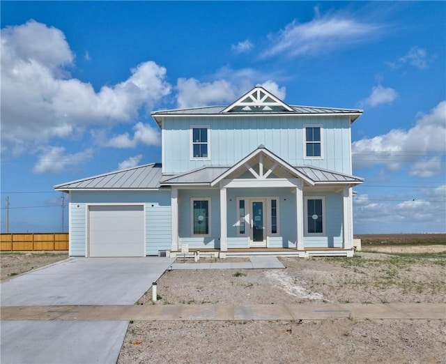 7518 Ruby Bay Ct, Port Aransas, TX 78373 - view of front of house featuring an attached garage, a standing seam roof, driveway, a porch, and metal roof