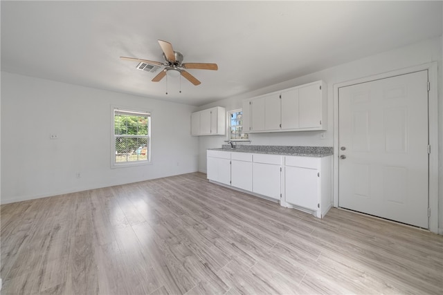 kitchen featuring white cabinets, ceiling fan, and light wood-type flooring