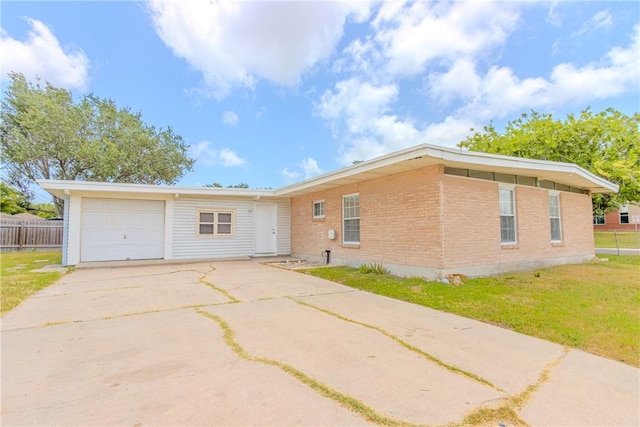 1553 Casa Grande Dr, Corpus Christi, TX 78411 - view of front facade with driveway, brick siding, and a garage