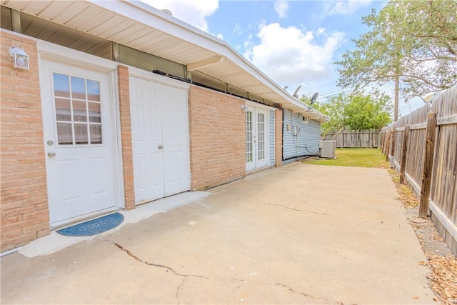 1553 Casa Grande Dr, Corpus Christi, TX 78411 - fenced backyard with cooling unit, a patio area, and french doors