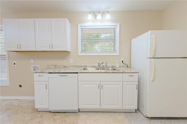 1553 Casa Grande Dr, Corpus Christi, TX 78411 - kitchen featuring white appliances, a sink, white cabinetry, and baseboards