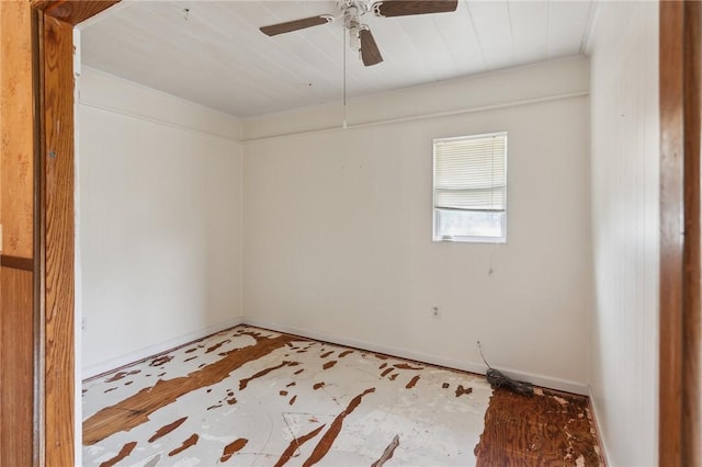 spare room with baseboards and a ceiling fan
