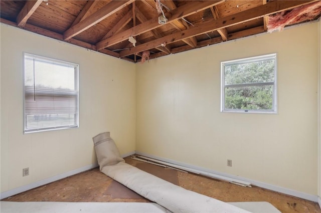 empty room with baseboards, wooden ceiling, and vaulted ceiling with beams