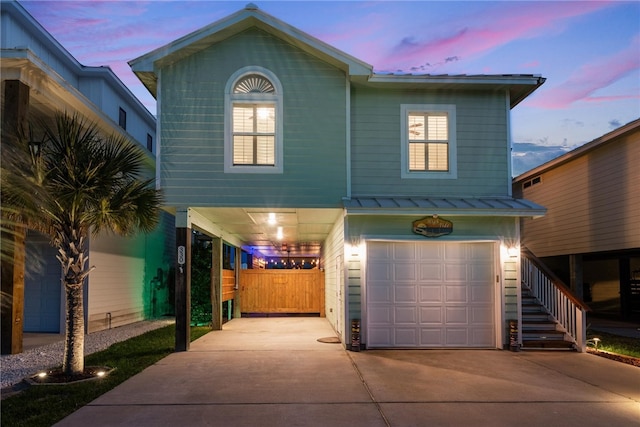 front of property featuring a garage and a carport