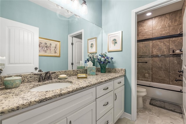 full bathroom with bath / shower combo with glass door, vanity, and toilet