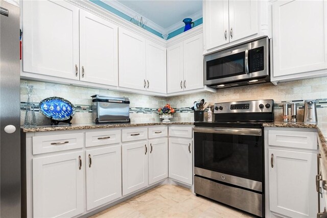 330 Paradise Pointe Dr, Port Aransas, TX 78373 - kitchen with appliances with stainless steel finishes, white cabinetry, and stone counters