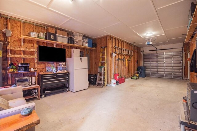 330 Paradise Pointe Dr, Port Aransas, TX 78373 - garage featuring freestanding refrigerator and a garage door opener