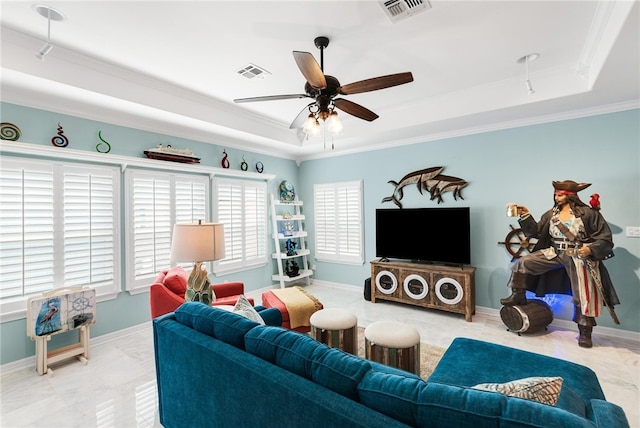 living room featuring ceiling fan, crown molding, and a raised ceiling