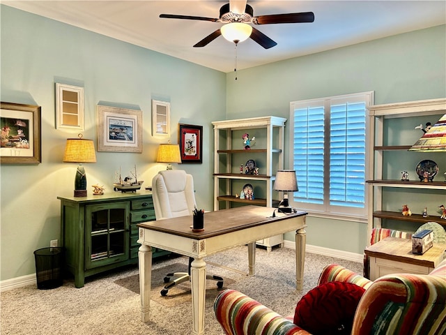 home office with light carpet and ceiling fan