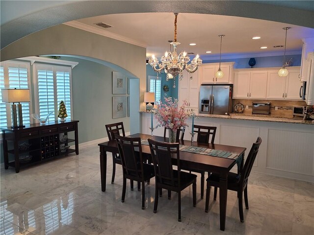330 Paradise Pointe Dr, Port Aransas, TX 78373 - dining space with crown molding, a chandelier, arched walkways, light marble finish flooring, and recessed lighting