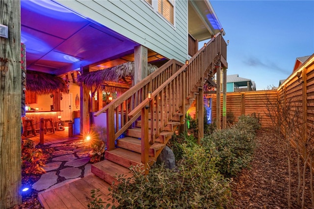 property exterior at dusk featuring a patio area