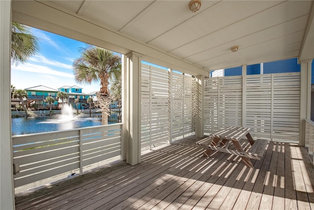 wooden deck featuring a water view