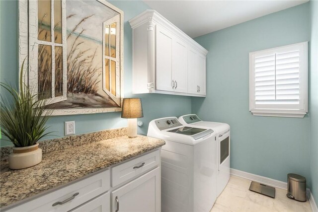 330 Paradise Pointe Dr, Port Aransas, TX 78373 - clothes washing area featuring independent washer and dryer, light marble finish floors, baseboards, and cabinet space