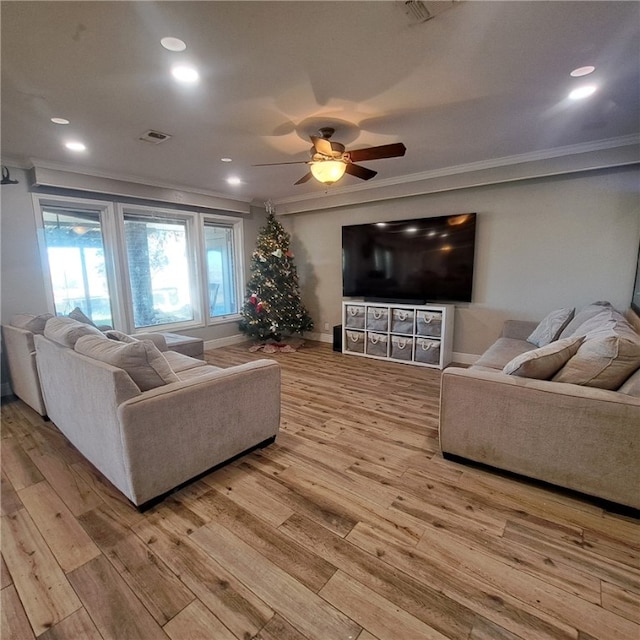 living room featuring light hardwood / wood-style flooring and ornamental molding