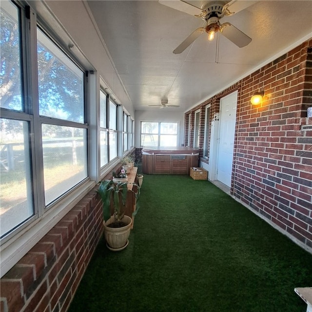 sunroom / solarium with ceiling fan