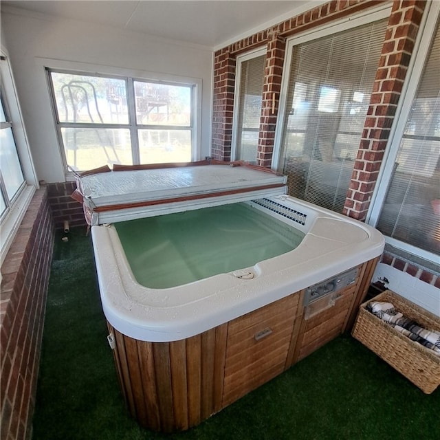 sunroom featuring a jacuzzi