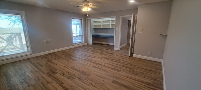 interior space featuring wood-type flooring and ceiling fan