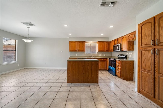 kitchen featuring decorative backsplash, stainless steel microwave, visible vents, and electric range oven