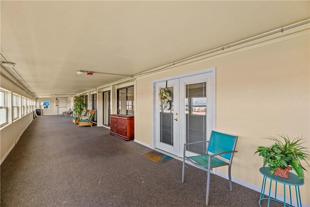 14300 S Padre Island Dr Unit 200, Corpus Christi, TX 78418 - unfurnished sunroom featuring french doors and carpet floors