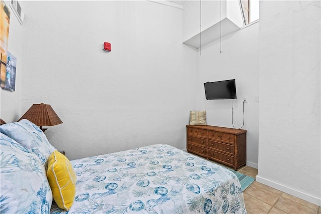14300 S Padre Island Dr Unit 200, Corpus Christi, TX 78418 - bedroom with baseboards and light tile patterned flooring
