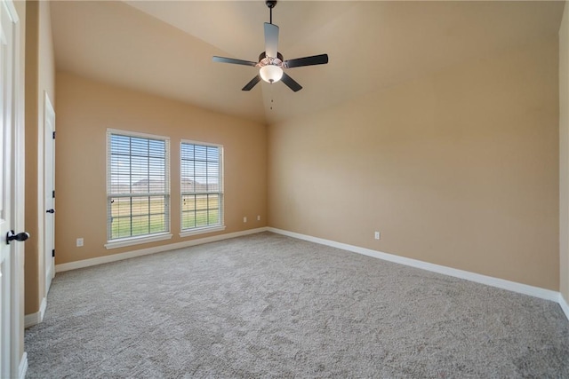 carpeted empty room with vaulted ceiling and ceiling fan