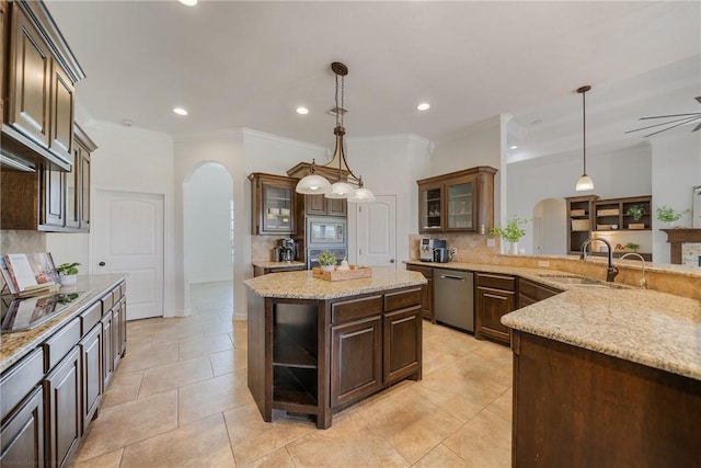 kitchen featuring dark brown cabinets, a center island, stainless steel appliances, and hanging light fixtures