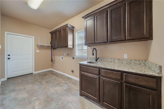 washroom with gas dryer hookup, cabinets, sink, hookup for a washing machine, and hookup for an electric dryer