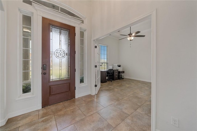 foyer entrance featuring ceiling fan