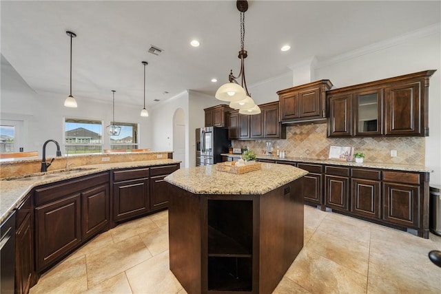 kitchen featuring sink, pendant lighting, dark brown cabinets, and stainless steel refrigerator with ice dispenser