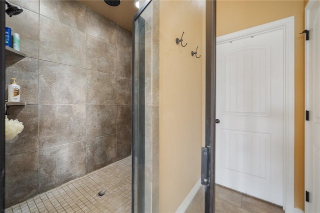 bathroom with tile patterned floors and walk in shower