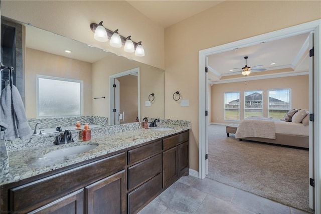 bathroom featuring vanity, tile patterned floors, ceiling fan, ornamental molding, and a tray ceiling