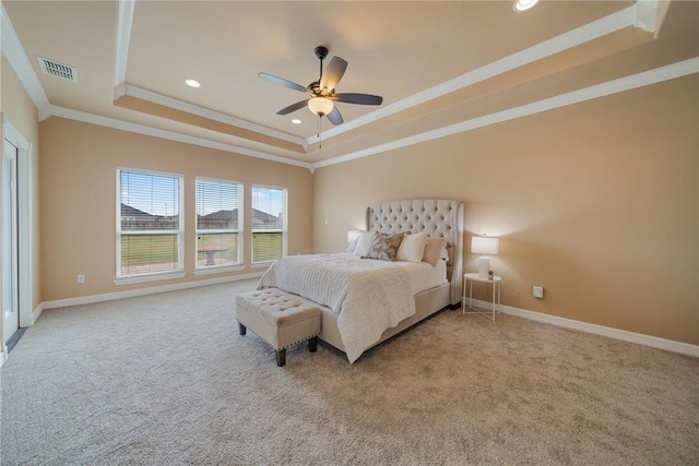 bedroom with carpet floors, a tray ceiling, ceiling fan, and crown molding