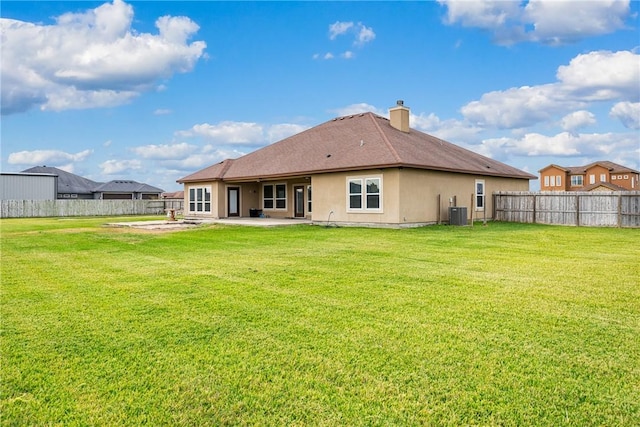 back of house featuring a lawn and central AC unit