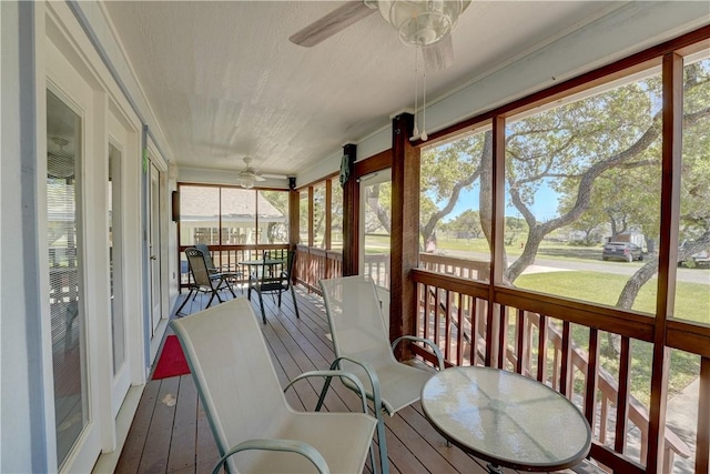 sunroom featuring ceiling fan