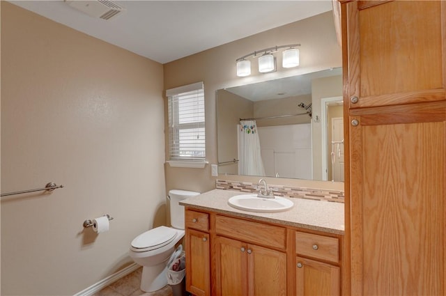 bathroom with tile patterned floors, vanity, a shower with shower curtain, and toilet