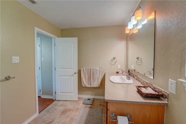 bathroom with tile patterned flooring and vanity