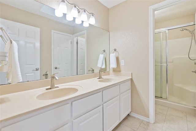 7030 Chiswick Dr, Corpus Christi, TX 78413 - bathroom featuring tile patterned flooring, a stall shower, and double vanity