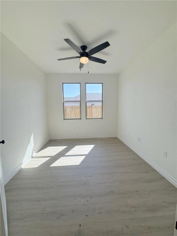 spare room with ceiling fan and light hardwood / wood-style flooring