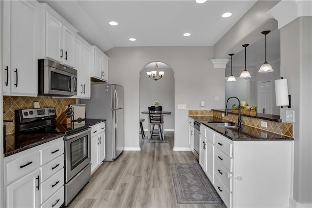 1119 Imperial St, Portland, TX 78374 - kitchen featuring stainless steel appliances, a sink, arched walkways, a peninsula, and tasteful backsplash